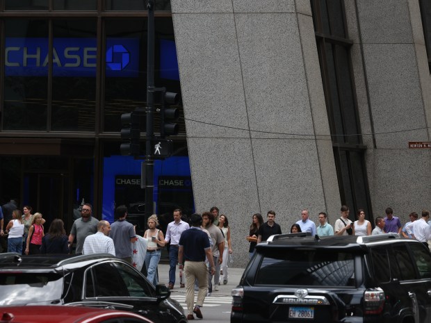 People walk at the base of Chase Tower in Chicago's Loop on June 26, 2024. (Antonio Perez/Chicago Tribune)