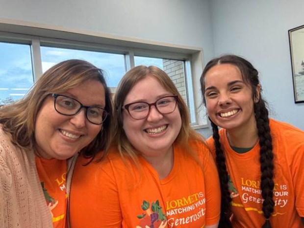 Staff at LorMet Credit Union's Avon Lake branch, Denise Kuzela, left, Branch Manager Faith Knittl, and Ariana Morales, promote the member match campaign for Second Harvest Food Bank by wearing themed T-shirts. (Submitted)